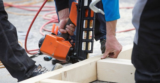 Carpenter building a stud wall