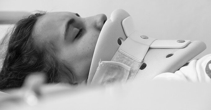 Patient in a neck brace